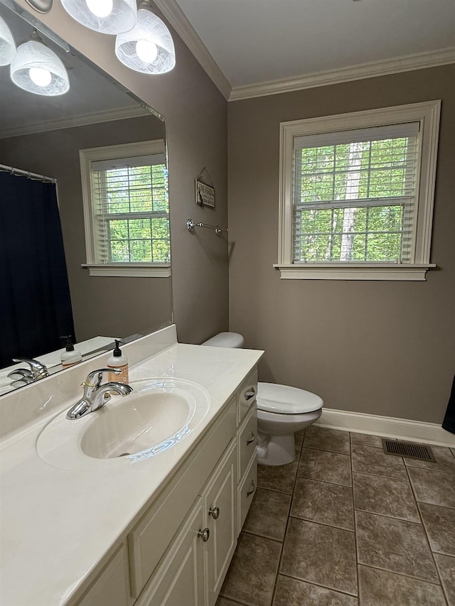 bathroom featuring crown molding, vanity, toilet, baseboards, and visible vents