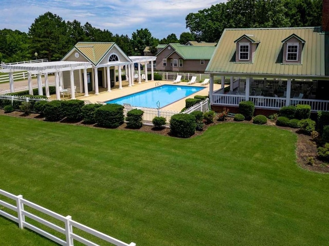 view of pool featuring a lawn, a pergola, and fence