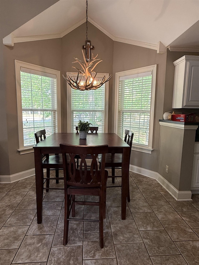 dining area with dark tile patterned floors, a wealth of natural light, lofted ceiling, and a chandelier