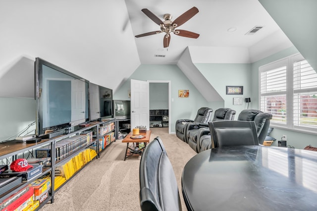 carpeted living area with ceiling fan, lofted ceiling, and visible vents