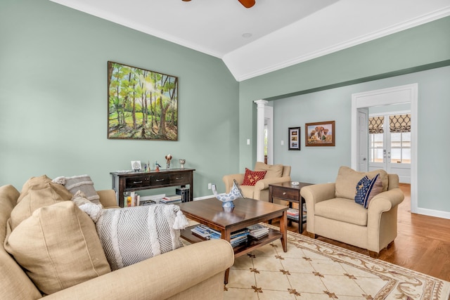 living room with ornamental molding, decorative columns, wood finished floors, baseboards, and ceiling fan