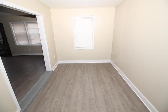 unfurnished room featuring baseboards and wood finished floors