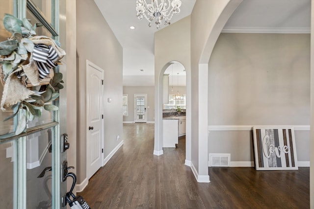 5376 Scarlet Ridge Dr, Arlington, TN 38002 - foyer entrance featuring visible vents, arched walkways, dark wood finished floors, baseboards, and an inviting chandelier