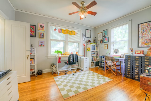 home office with crown molding, a ceiling fan, baseboards, and wood finished floors