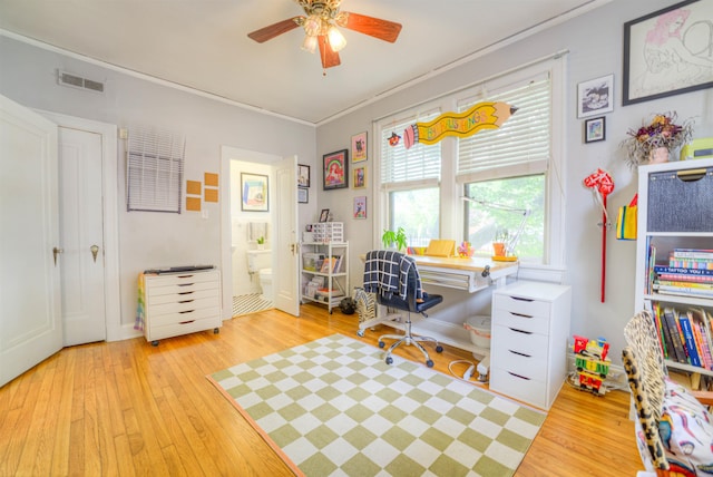 office space featuring ornamental molding, hardwood / wood-style flooring, ceiling fan, and visible vents