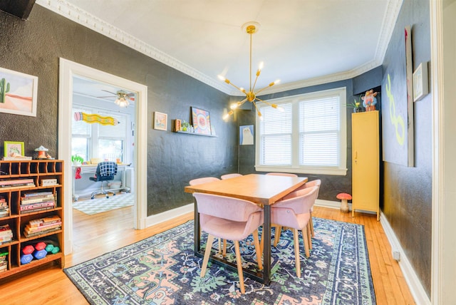 dining room with crown molding, a textured wall, wood finished floors, and a chandelier