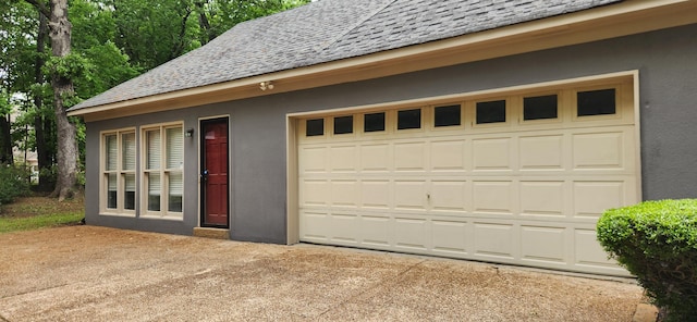 garage with concrete driveway