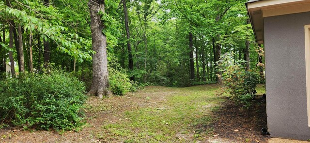 view of yard with a view of trees