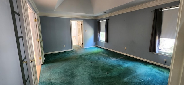 unfurnished bedroom with baseboards, ornamental molding, and carpet