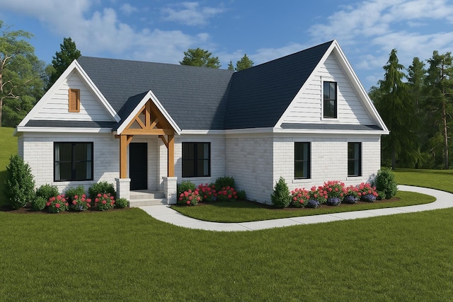 modern inspired farmhouse with brick siding and a front yard