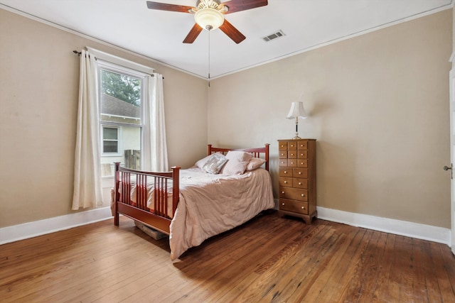 bedroom with wood-type flooring, baseboards, and visible vents