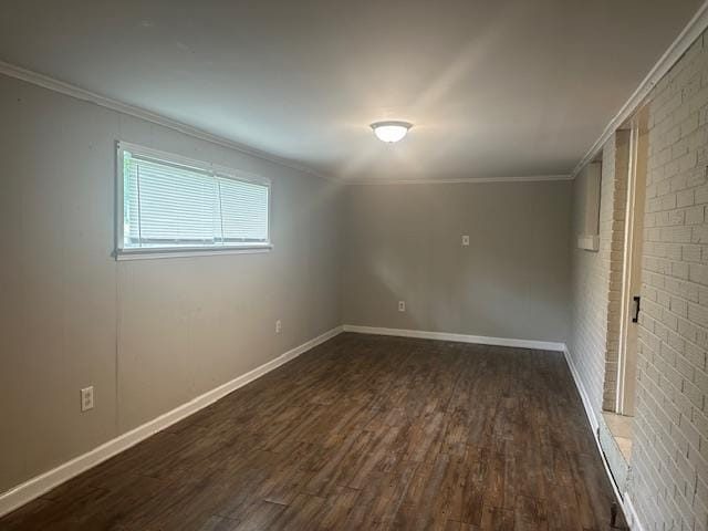 empty room with baseboards, ornamental molding, and dark wood-style floors