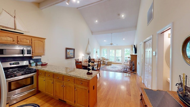 50 Red Oak Pt, Savannah, TN 38372 - kitchen featuring high vaulted ceiling, beamed ceiling, a peninsula, light wood-style floors, and stainless steel appliances
