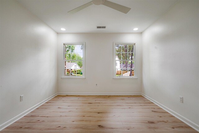 empty room featuring ceiling fan, recessed lighting, baseboards, light wood-type flooring, and visible vents