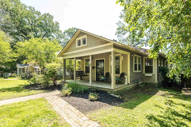 view of front of property with covered porch and a front yard