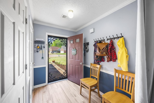 6747 Wild Ln, Bartlett, TN 38135 - foyer featuring crown molding, a textured ceiling, light wood-style flooring, baseboards, and visible vents