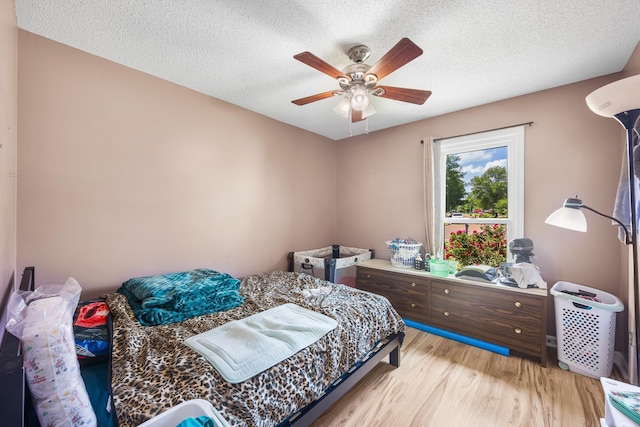 6747 Wild Ln, Bartlett, TN 38135 - bedroom featuring a textured ceiling, light wood finished floors, and ceiling fan