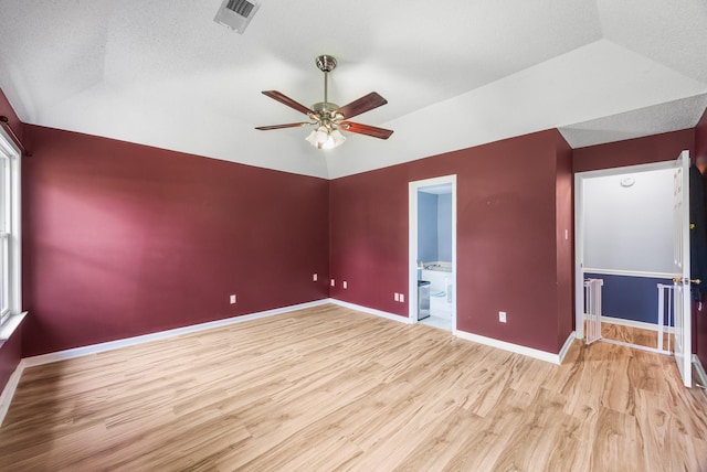 6747 Wild Ln, Bartlett, TN 38135 - unfurnished room featuring ceiling fan, visible vents, baseboards, lofted ceiling, and light wood-style floors