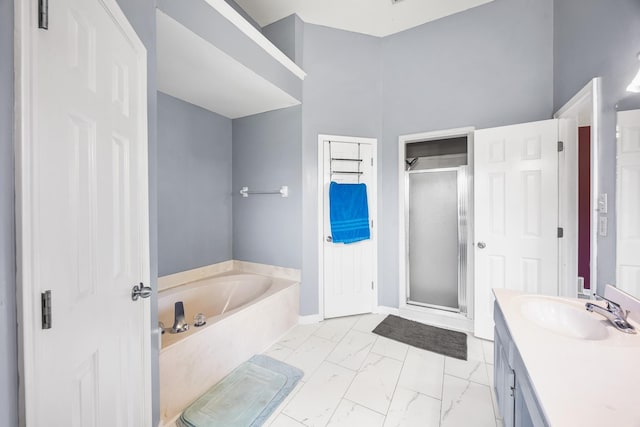 6747 Wild Ln, Bartlett, TN 38135 - full bathroom featuring a garden tub, vanity, marble finish floor, baseboards, and a stall shower