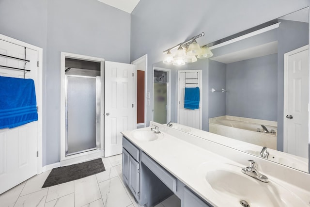 6747 Wild Ln, Bartlett, TN 38135 - bathroom featuring a sink, marble finish floor, a bath, and a shower stall