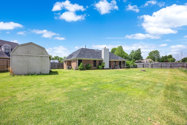 6747 Wild Ln, Bartlett, TN 38135 - view of yard with a fenced backyard, a storage unit, and an outdoor structure