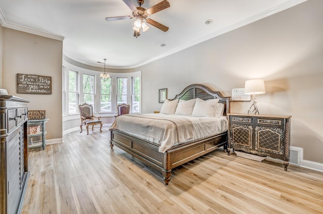 bedroom with crown molding, baseboards, light wood finished floors, and visible vents