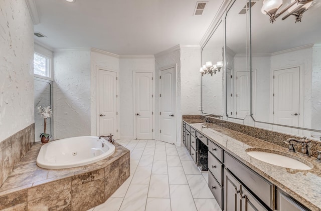 full bathroom featuring a whirlpool tub, a textured wall, visible vents, and a sink
