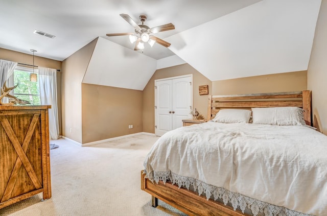 carpeted bedroom featuring ceiling fan, visible vents, baseboards, a closet, and lofted ceiling
