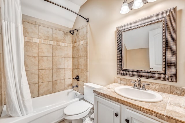 bathroom featuring vanity, shower / bath combo with shower curtain, and toilet