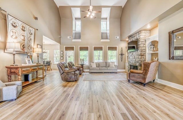 living area featuring a healthy amount of sunlight, ceiling fan, and wood finished floors