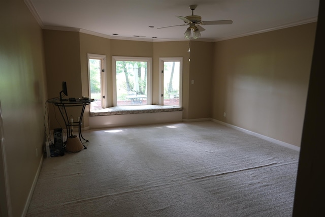 unfurnished room with baseboards, crown molding, carpet, and ceiling fan