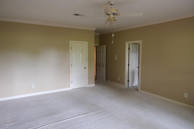 unfurnished room featuring ceiling fan, visible vents, baseboards, ornamental molding, and light carpet