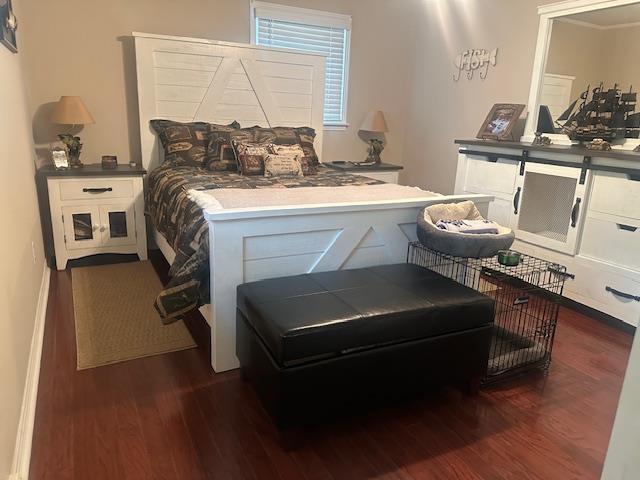 bedroom with dark wood-type flooring