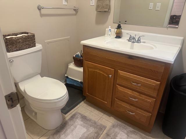 bathroom with vanity, tile patterned floors, and toilet