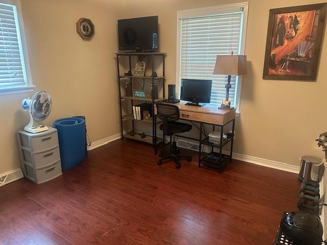 home office with baseboards and wood finished floors