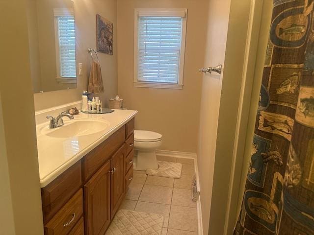 full bath with tile patterned flooring, plenty of natural light, toilet, and vanity