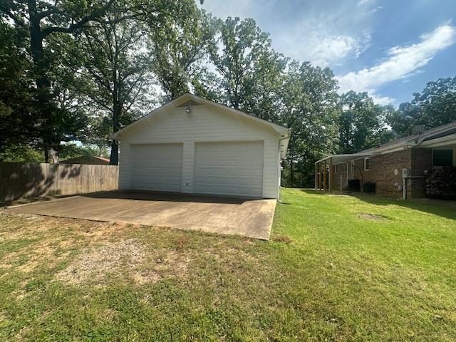 detached garage featuring fence