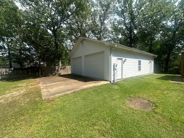 detached garage featuring fence