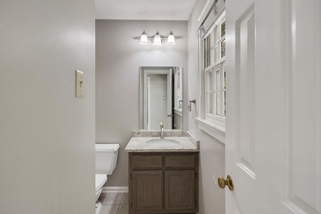 3365 Stone Creek Cv, Collierville, TN 38017 - bathroom featuring tile patterned flooring, vanity, toilet, baseboards, and a textured ceiling