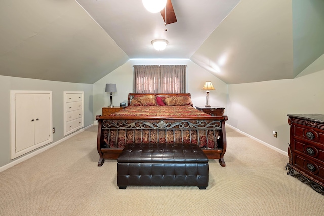 carpeted bedroom featuring baseboards and lofted ceiling