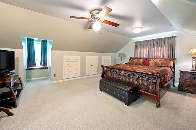 carpeted bedroom featuring a ceiling fan, baseboards, and lofted ceiling