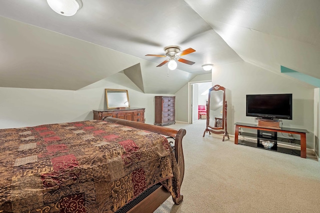 carpeted bedroom with a ceiling fan and vaulted ceiling