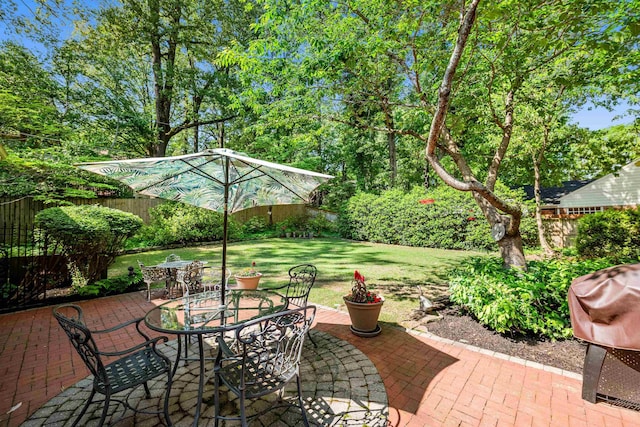 view of patio / terrace featuring fence and outdoor dining area