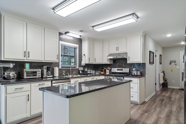 90 Shaker Dr, Senatobia, MS 38668 - kitchen featuring backsplash, white cabinets, gas range, and a toaster