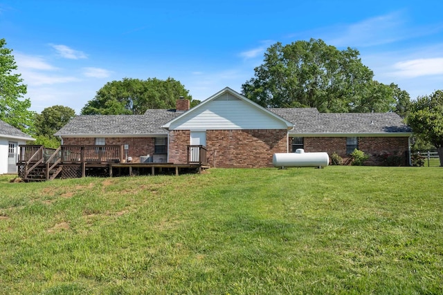 90 Shaker Dr, Senatobia, MS 38668 - back of house featuring brick siding, a lawn, a chimney, and a deck