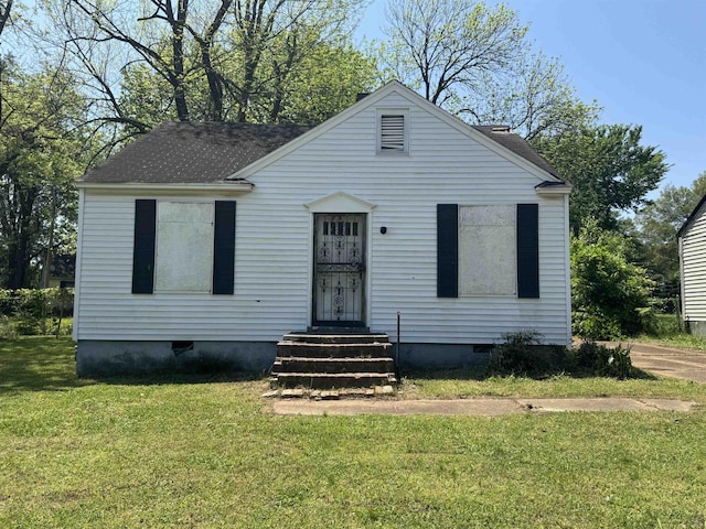 bungalow-style house with crawl space, entry steps, roof with shingles, and a front lawn