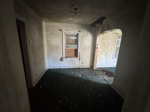 empty room with visible vents and ornamental molding