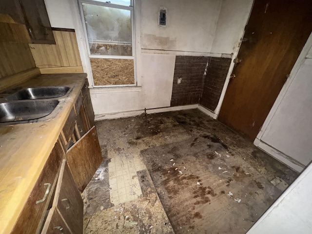 interior space with a sink and wainscoting