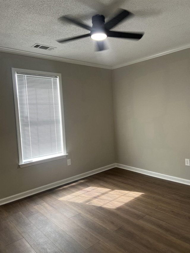spare room featuring a textured ceiling, ornamental molding, dark wood-style flooring, and ceiling fan