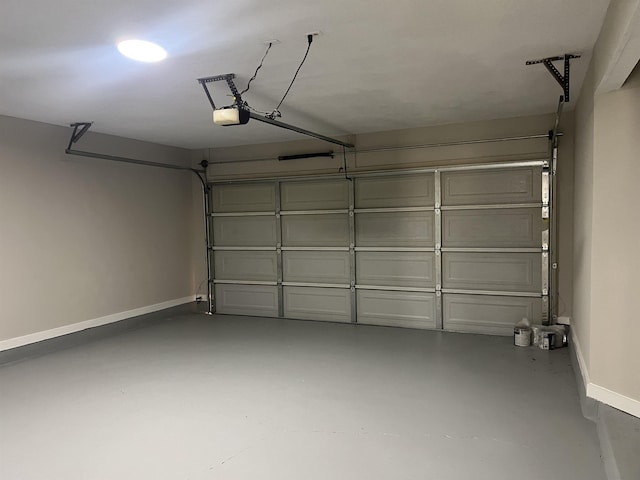 garage featuring baseboards and a garage door opener
